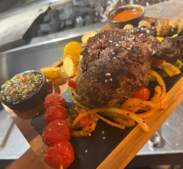 Steak with grilled vegetables and sauces